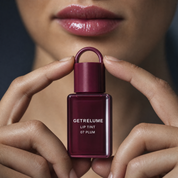 Close-up of glossy plum lips with RELUME Juicy Lip Tint